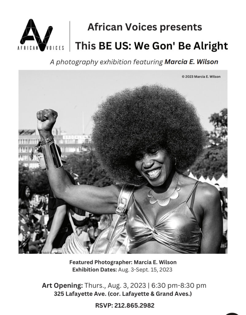 A promotional poster for the photography exhibition "This BE US: We Gon' Be Alright" by Marcia E. Wilson, presented by African Voices. The poster includes an image of a woman with an Afro, raising her fist and smiling. The exhibition runs from Aug. 3 to Sept. 15, 2023, with an art opening on Aug. 3. RSVP details are included.